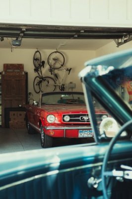 Garage with bikes hanging above a parked mustang
